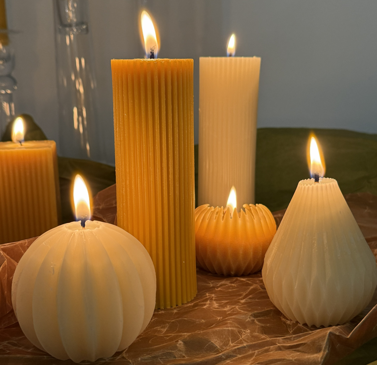 Våra olika bivaxljus, tända på ett bord